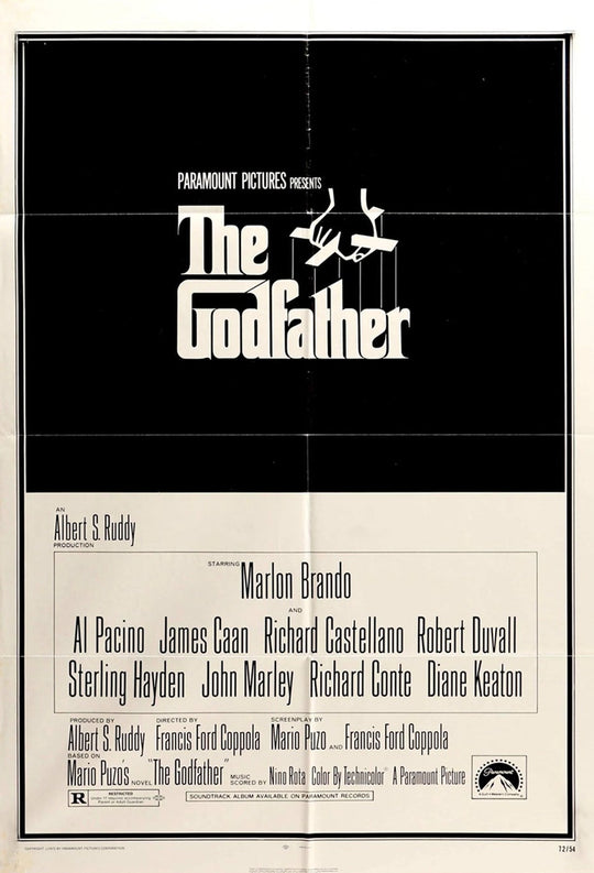 Framed movie poster for 'The Godfather' with a black and white design.