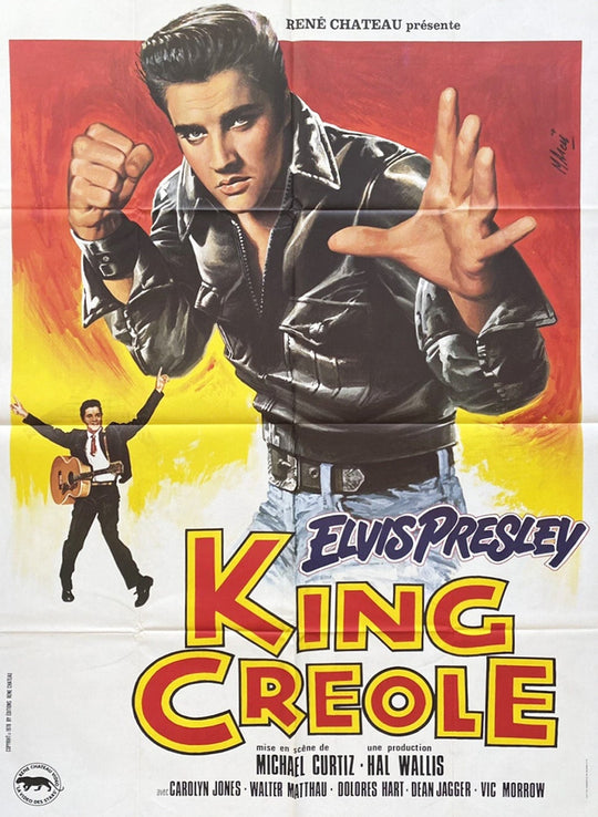 Vintage movie poster for 'King Creole' featuring Elvis Presley with a red and yellow background.