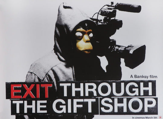 Poster of a monkey with a camera, labeled 'Exit Through the Gift Shop' by Banksy.