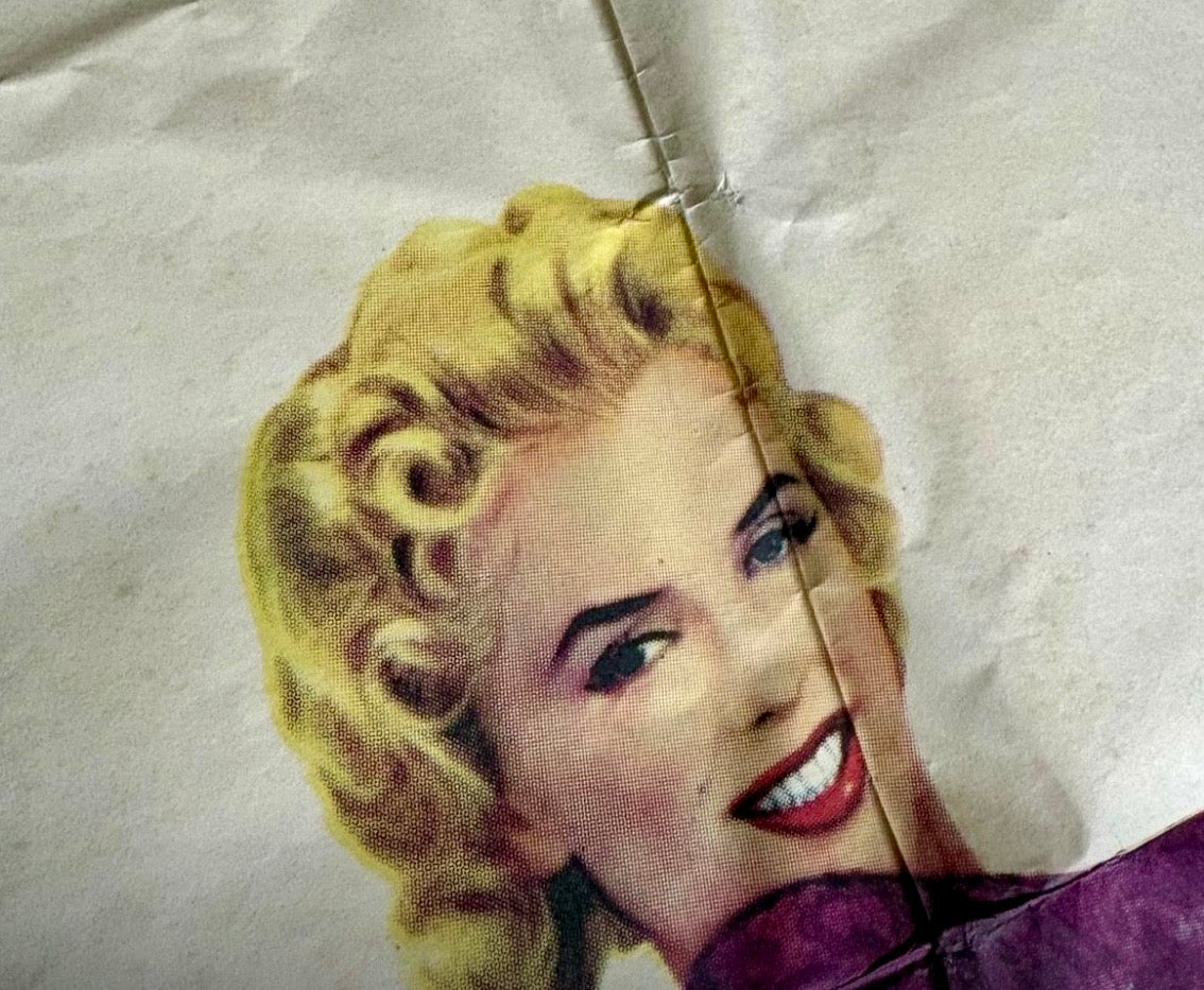 Close-up detail of a period fold line on an original poster