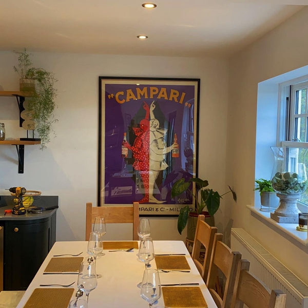 Campari poster above the dining table