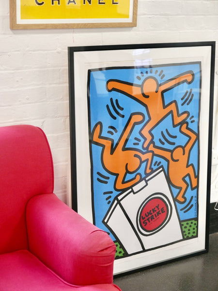 Keith Haring “Lucky Strike” poster, beside the armchair