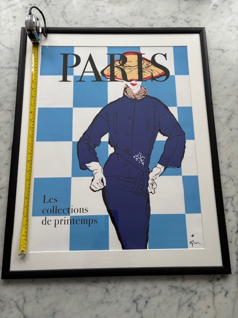 A Paris fashion poster being measured against its expected size before listing