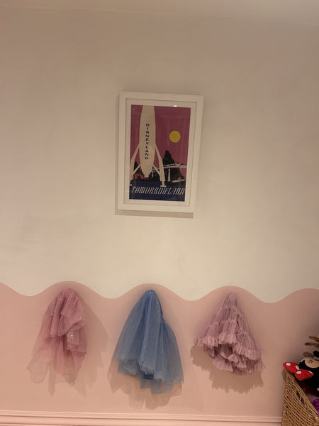 Disneyland “Tomorrowland” poster in a child’s room