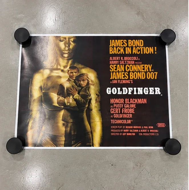 An original Goldfinger UK quad flat and unframed, held down with weights