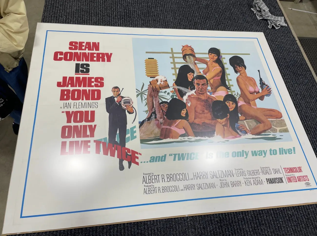 An original You Only Live Twice UK quad laid out flat and unframed, being measured up before framing