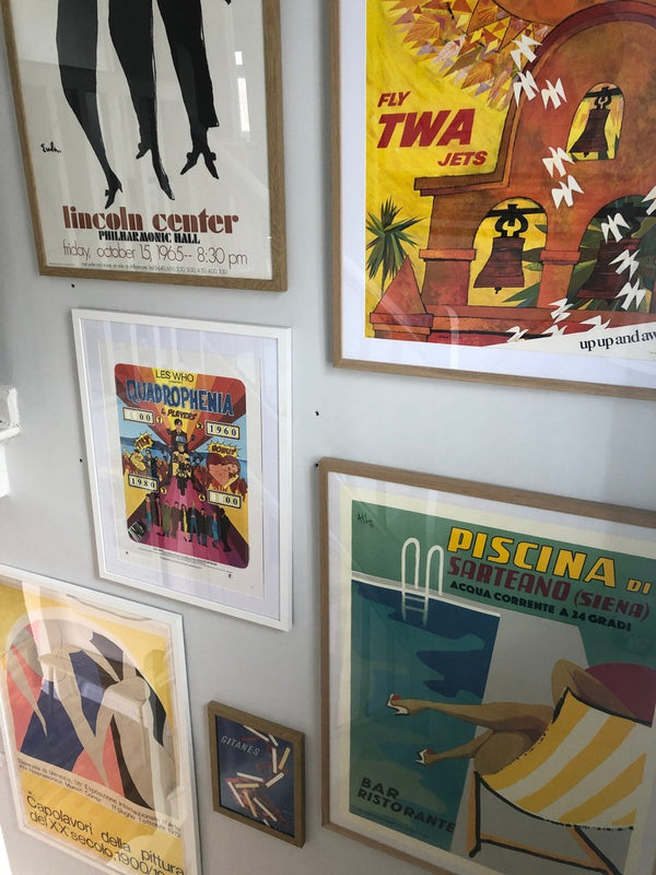 A gallery wall of original vintage posters in a customer's home