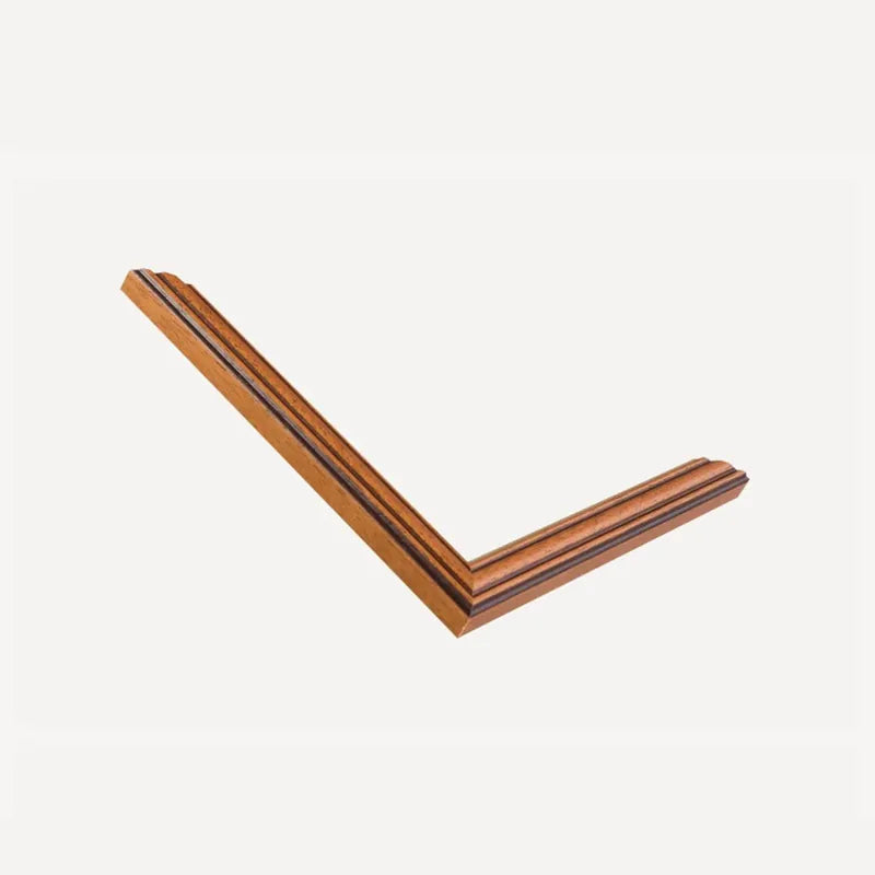 Mitred corner of our teak moulding, a warm wood with a fine gold inner line