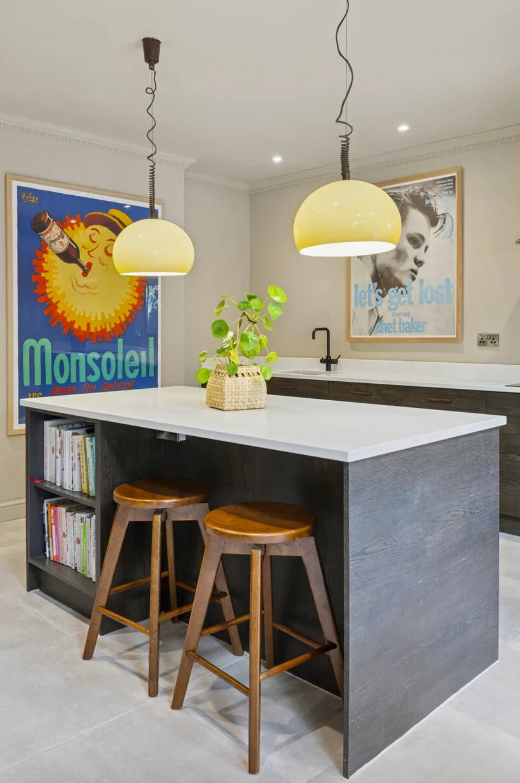 Framed original Monsoleil and Chet Baker posters hanging in a customer's kitchen