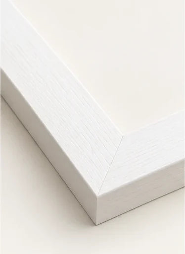 Mitred corner of our white moulding, showing the grain through the white finish