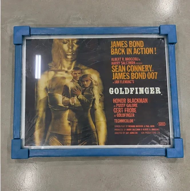 A finished frame wrapped in protective film with foam corner protectors, ready for transit