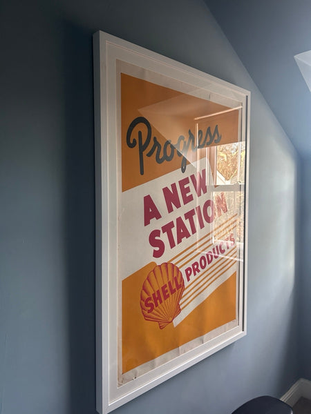 “Progress – A New Station” (Shell) poster in a blue bedroom